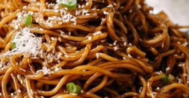 Delicious Asian Garlic Noodles served with fresh herbs and toppings