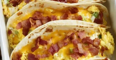 Delicious baked breakfast tacos with eggs, cheese, and toppings