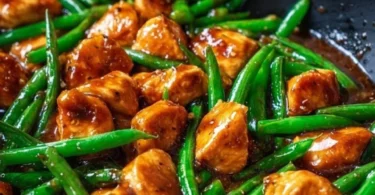 Delicious chicken breast served with fresh green beans on a plate