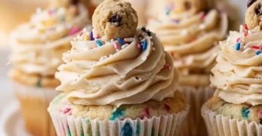 Delicious Cookie Dough Cupcakes topped with cookie dough and chocolate frosting