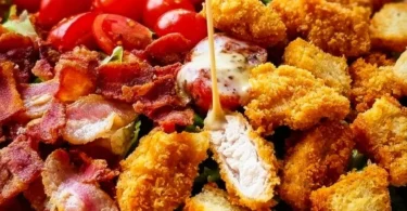 Crispy Chicken BLT Salad with lettuce, tomatoes, and bacon on a plate
