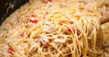 Crock Pot Cheesy Chicken Spaghetti with cheese and chicken in a pot
