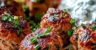 Plate of Greek turkey meatballs with tzatziki sauce and garnishes