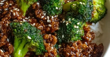 Plate of hamburger meat and broccoli stir-fry on a wooden table