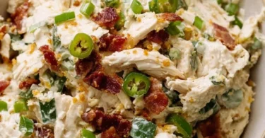 Bowl of jalapeño popper chicken salad with fresh ingredients and spices