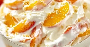 Delicious Peach Cheesecake Salad topped with fresh peach slices and creamy cheesecake dressing.