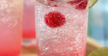 Glass of Raspberry Key Lime Soda with ice and garnish