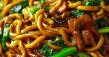 Plate of savory Shanghai Fried Noodles with colorful vegetables and toppings