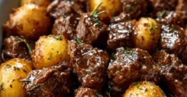 Slow cooker garlic butter beef bites served with tender potatoes
