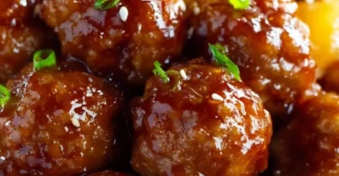 Slow cooker teriyaki meatballs served on a plate with garnish