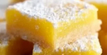 Delicious super easy lemon bars on a white plate