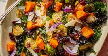 Warm roasted veggie salad with maple Dijon vinaigrette in a bowl
